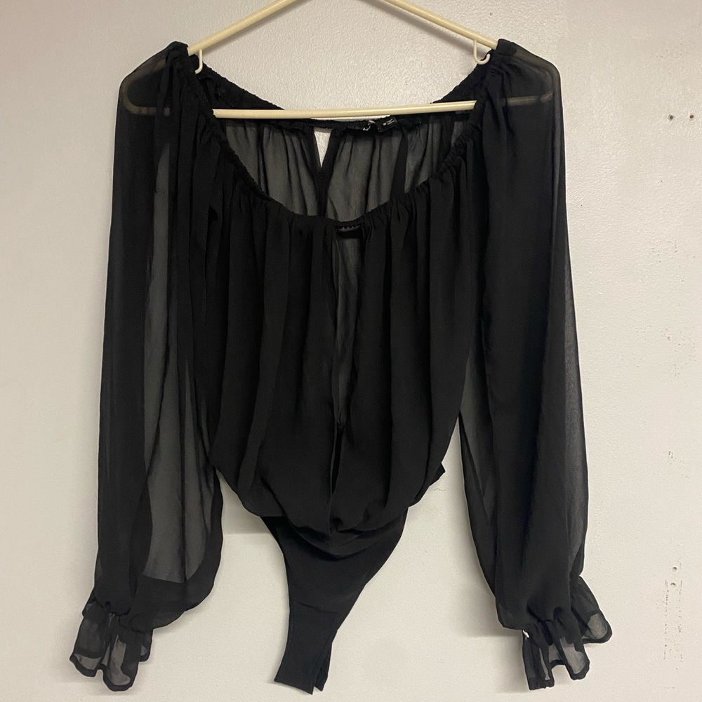 Black see-through bodysuit with opening in the front and in the sleeves